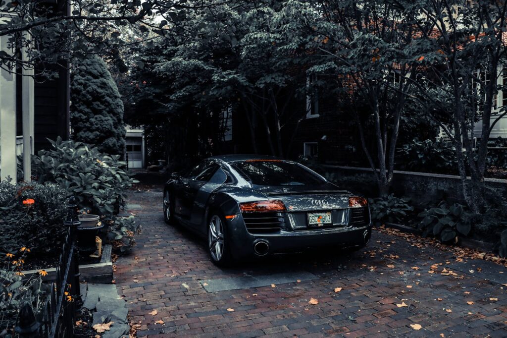 pexels-photo-1402787 A sleek Audi R8 parked in a leafy residential driveway in Cape May, NJ, showcasing elegance and luxury.
